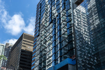 Low angle view of modern building against sky in city