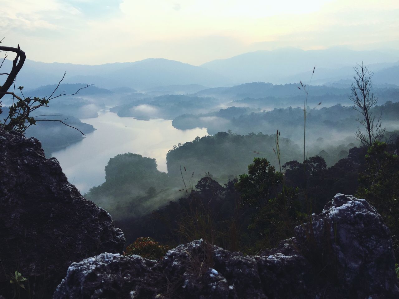 mountain, mountain range, scenics, tranquil scene, beauty in nature, tranquility, sky, nature, tree, landscape, fog, cloud - sky, weather, non-urban scene, idyllic, outdoors, rock - object, no people, day, high angle view