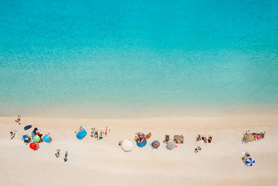 High angle view of people at beach against blue sky