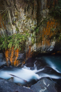 Scenic view of stream flowing through rocks