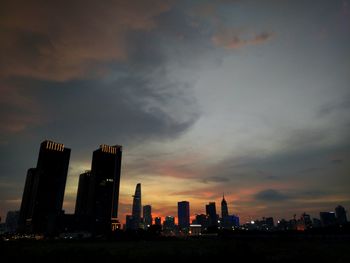 Silhouette buildings against sky during sunset