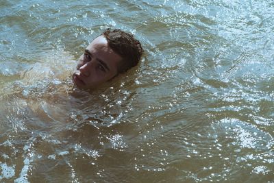 High angle view of man swimming in sea