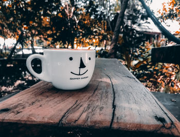 Close-up of coffee cup on wood