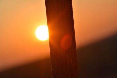 Close-up of orange sun against sky during sunset