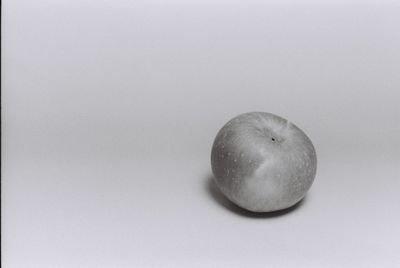 High angle view of apple on table against white background