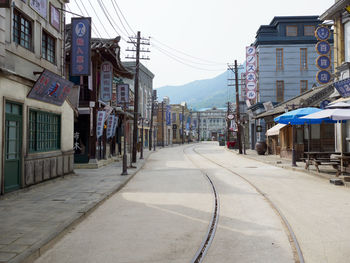 Street amidst buildings in city against sky