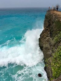 Waves breaking on cliff