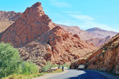 Road amidst rocks against sky