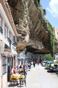 People on street amidst buildings in city