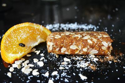 Close-up of orange slice with granola bar