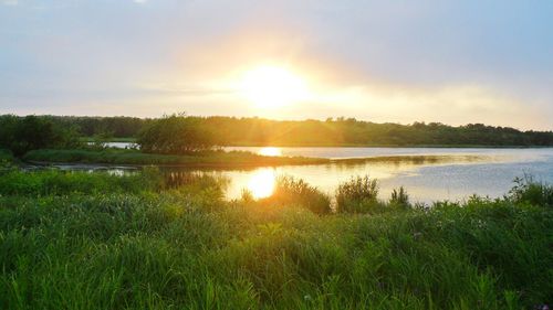 Scenic view of lake against sky during sunset