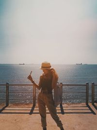 Woman standing on promenade against sky