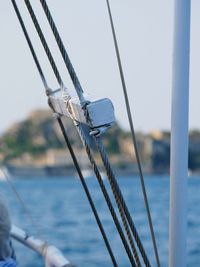 Close-up of ship sailing in sea against clear sky