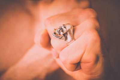 Close-up of person wearing skull ring