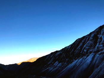 Scenic view of snowcapped mountain against blue sky