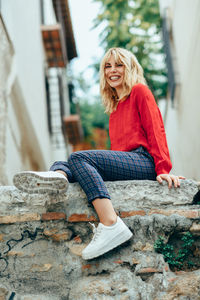 Portrait of smiling woman sitting outdoors