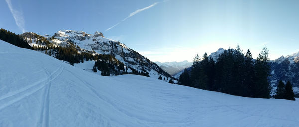 Scenic view of snow mountains against sky