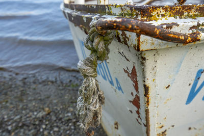 Close-up of rope tied on metal boat