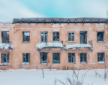 Low angle view of building against sky during winter