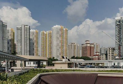 Low angle view of buildings against cloudy sky