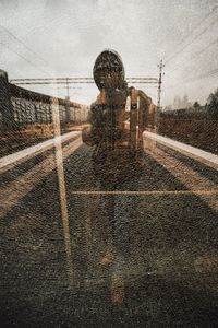 Man standing on wet road in rainy season