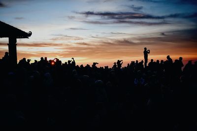 Silhouette people against sky during sunset