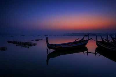 Gondora boat. a fisherman wooden boat parked under the u-bein bridge at sunrise. amarapura, mynmar.