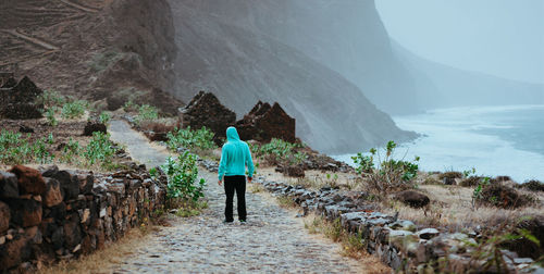 Male enjoy landscape of rugged coastline on the trekking trail to cruzinha. santo antao cape verde