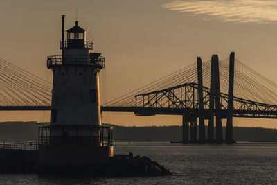 Silhouette of lighthouse at sunset