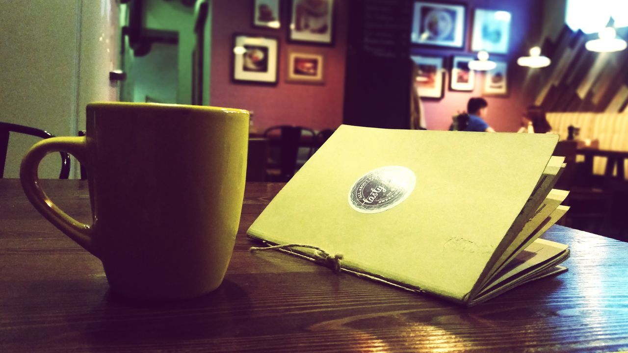 indoors, table, still life, food and drink, coffee cup, drink, refreshment, close-up, coffee - drink, freshness, cup, focus on foreground, coffee, home interior, communication, book, restaurant, cafe, no people, wood - material