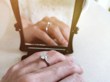 Close-up of woman holding mirror