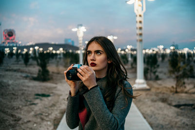 Portrait of beautiful young woman using smart phone