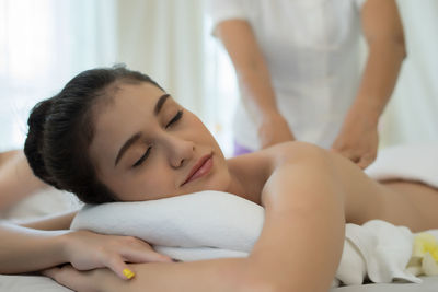 Young woman receiving massage in spa