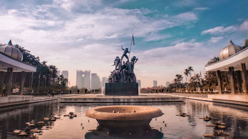 Sculptures against cloudy sky