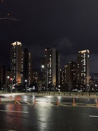 Illuminated modern buildings in city at night