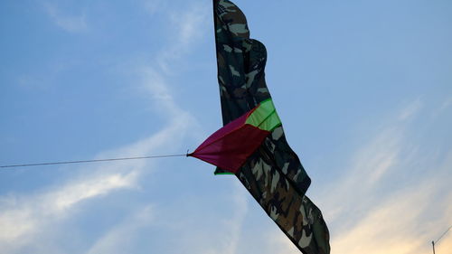 Low angle view of flags hanging against sky