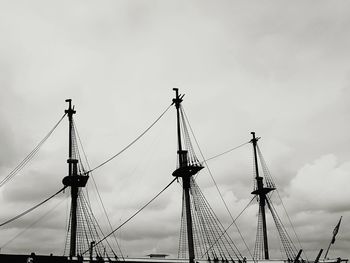 Low angle view of masts against sky