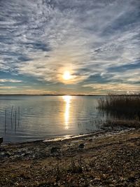 Scenic view of lake against sky during sunset