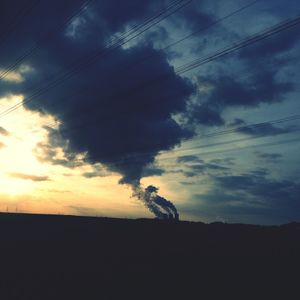 Silhouette of landscape against cloudy sky