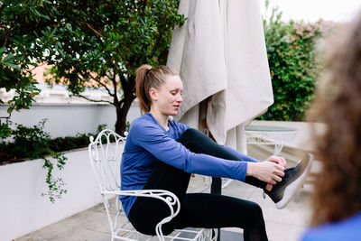 Woman sitting on seat in park