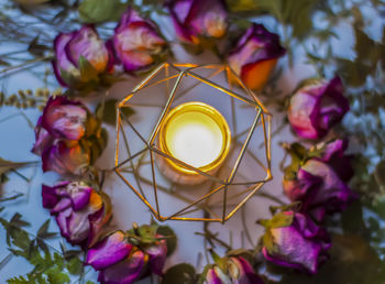 Close-up of decorations. candle and dry roses.