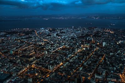 Aerial view of illuminated cityscape against sky