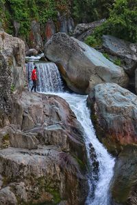 Scenic view of waterfall amidst rocks