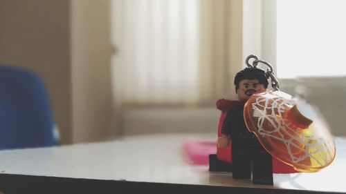 Boy with toy on table at home