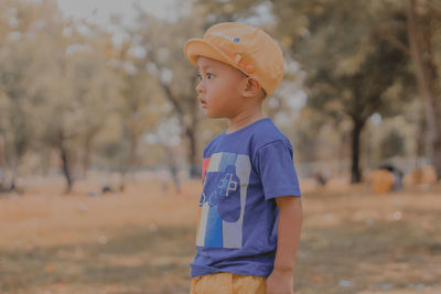Side view of boy standing outdoors