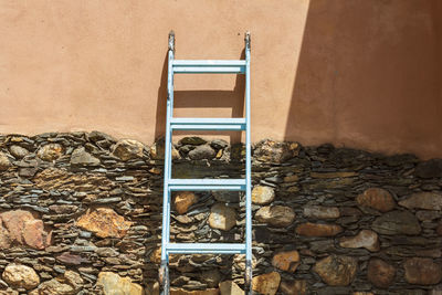 Blue step ladder against the wall