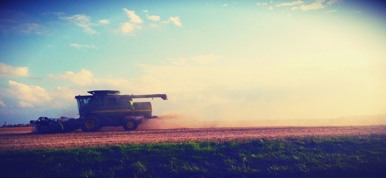 agriculture, field, sky, growth, rural scene, nature, combine harvester, no people, beauty in nature, plant, flower, scenics, outdoors, cloud - sky, landscape, day, oilseed rape, freshness