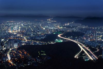 High angle view of illuminated buildings in city at night