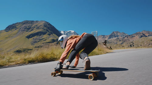 Rear view of man walking on road