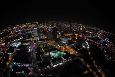 Illuminated cityscape against sky at night